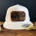 White snapback hat with scalloped espresso cowhide patch and red hand-stitched border, branded with a registered cattle brand