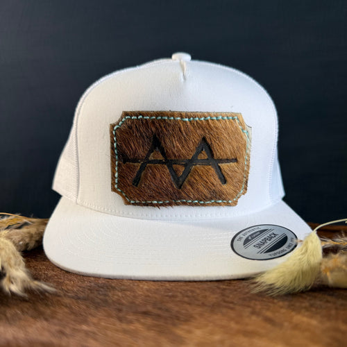 White snapback hat with warm brown scalloped cowhide patch and mint turquoise hand-stitched border, branded with a registered cattle brand