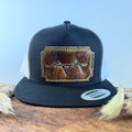 Black and white trucker snapback hat with scalloped warm brown cowhide patch and neon yellow-green hand-stitched border, branded with a registered cattle brand