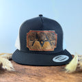 Black and white trucker snapback hat with scalloped multi-toned brindle cowhide patch and red hand-stitched border, branded with a registered cattle brand