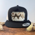 Black and white trucker snapback hat with scalloped pale cream and gold speckled cowhide patch and mint green hand-stitched border, branded with a registered cattle brand