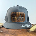 Charcoal grey snapback hat with deep espresso brindle cowhide patch and copper tonal stitched border, branded with a registered cattle brand